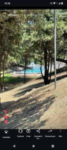 a view of a park with trees and a lake at Hotel ALTOS DE ARUNA in Bialet Massé