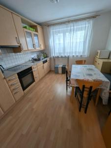 a kitchen with a table and a dining room at Ferienwohnung mit Garten in der Nähe Landshut in Geisenhausen +4 photos