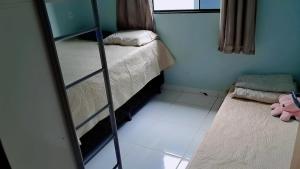 Habitación pequeña con litera y espejo. en Conforto e Lazer! Casa com Piscina e 3 Quartos, en Palmas