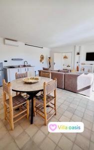 Villa Oasis Marrakech في مراكش: مطبخ وغرفة معيشة مع طاولة وكراسي +20 صورة
