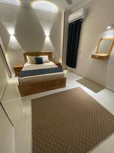 a bedroom with a bed and a rug at Luxe Nest Guest House Apartment 21 in Luxor