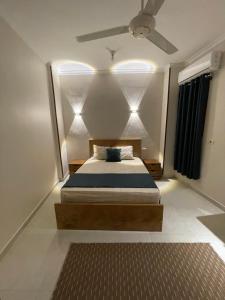 a bedroom with a bed with a ceiling fan at Luxe Nest Guest House Apartment 21 in Luxor