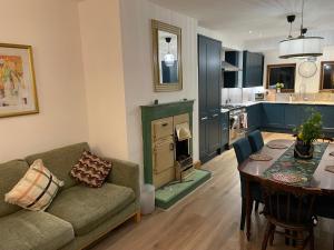 a living room with a couch and a table and a kitchen at "Ivyholme" Superb Premium House in Central Durham Location in Durham +39 photos