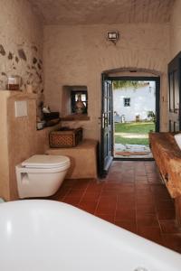 a bathroom with a toilet and an open door at Usedlost Ledňáček - Boutique Wellness & SPA in Písečné