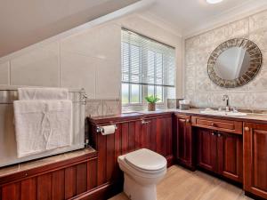 a bathroom with a toilet and a sink and a mirror at 2 Bed in Winterborne Stickland 95140 in Winterborne Stickland +16 photos