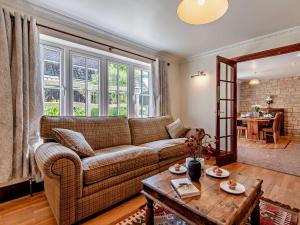 a living room with a couch and a table at 2 Bed in Winterborne Stickland 95140 in Winterborne Stickland