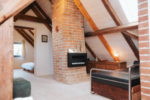 a room with a brick wall and a fireplace at Usedlost Ledňáček - Boutique Wellness & SPA in Písečné