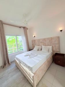 Ένα ή περισσότερα κρεβάτια σε δωμάτιο στο Bliss Homes at Fumba Town +18 φωτογραφίες