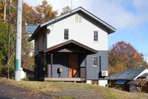 a house with a black and white exterior at THE KOYA Nagano in Nagano