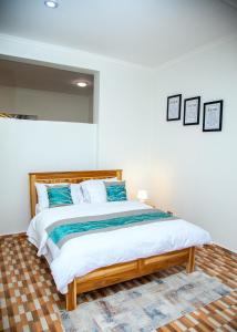 多多马JMG Homes的卧室里有一张大床，配有蓝色枕头