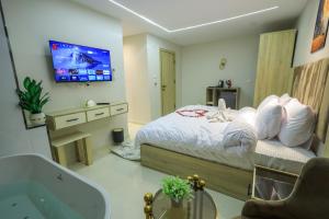 a bedroom with a bed and a tv on the wall at First Site OF Pyramids View & Jacuzzi in Cairo +23 photos
