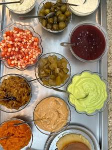a table topped with different types of food in bowls at Hotel Vitoria Marchi in Serra Negra