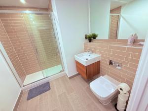 a bathroom with a toilet and a sink and a shower at Best Area Stylish1Bed, Games, Relax, Parking in Birmingham