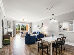 a living room with a table and chairs at Sanctuary at Redfish 1106 by Newman-Dailey in Blue Mountain Beach