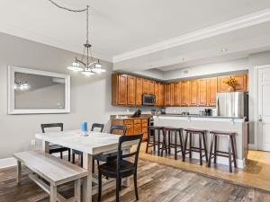 a kitchen and dining room with a table and chairs at Sanctuary at Redfish 1106 by Newman-Dailey in Blue Mountain Beach