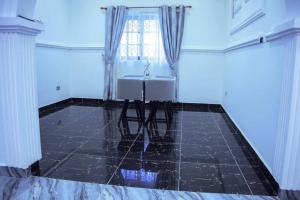 a white room with a chair and a window at Rych Lodge in Koleman