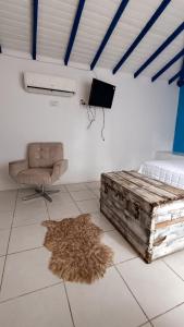 a bedroom with a bed and a chair and a rug at Paradise Búzios in Búzios