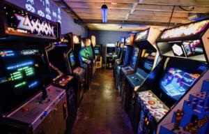 a row of arcade video games in a room at 1980's Themed Room with MASSIVE 80's Arcade in Winston-Salem