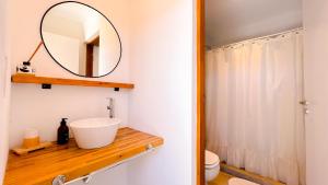 a bathroom with a sink and a mirror at Casa Altamar - Casa Con Vista Al Mar en Playa Cruz del Sur, Chapadmalal Para 6 PAX Con Parrilla y Cochera - Hola Sur in Chapadmalal +20 photos
