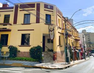 a building on the corner of a street at Hotel Vitoria Marchi in Serra Negra