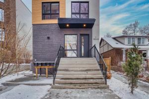 a house with a staircase in front of it at Luxurious Large 3 Bedroom Loft Saskatchewan Drive in Edmonton