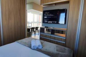 a bedroom with a bed and a flat screen tv at Aeroporto Gru, Ar Condicionado, Piscina+Academia 7 in Guarulhos +40 photos