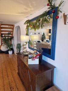 a living room with a mirror and a dresser at The Old Mill, Deluxe holiday home with a view in Menai Bridge
