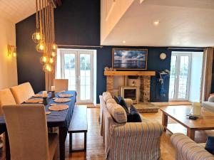 a living room with a table and a living room with a fireplace at The Old Mill, Deluxe holiday home with a view in Menai Bridge