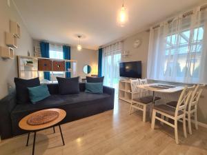 a living room with a couch and a dining room at APARTAMENTY "LA VILLA" SUPERIOR III na parterze z prywatnym ogrodem, tarasem, parkingiem, blisko centrum, spokojna okolica in Kudowa-Zdrój