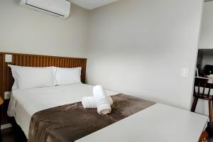 a bedroom with a bed with a white object on it at Aeroporto GRU e Shopping Maia, com Ar Condicionado in Guarulhos +34 photos