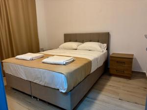 a bedroom with a large bed with two pillows on it at Sogular Apartments 1 in Aglantzia
