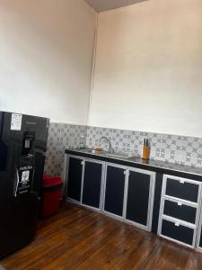 a kitchen with a sink and a counter top at Casa-Hostal La Casona in Roldanillo