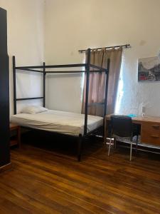 a bedroom with two bunk beds and a desk at Casa-Hostal La Casona in Roldanillo +7 photos