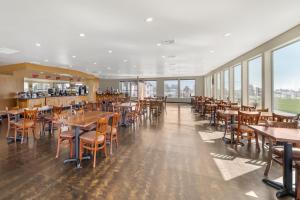a dining room with tables and chairs and windows at Best Western Plus Northwoods Inn in Crescent City