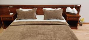 a bedroom with a large bed with pillows at Pensiunea Terra Serenity in Snagov +70 photos