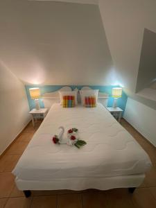 Ένα ή περισσότερα κρεβάτια σε δωμάτιο στο Tobago magnifique appartement vue mer complexe pierre et vacances