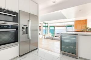 a kitchen with a stainless steel refrigerator at Gorgeous Malibu Retreat with #Instaworthy Ocean Views in Malibu Beach