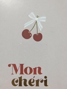 DoullensにあるLove Roomのリボンが付いた2つのチェリーと「モムガン」の文字が書かれた看板