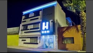 a building with a blue light on the side of it at Le Prince Arica in Arica