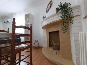 a living room with a fireplace and a staircase at El otro cielo Playamonte in Navarrés