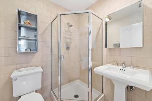 ein Badezimmer mit Dusche, Toilette und Waschbecken in der Unterkunft Laguna Beach Coastal Cottage in Laguna Beach