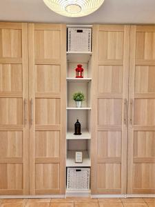 a closet with wooden doors and a chandelier at Apartamento Sant Josep in Canet de Mar +22 photos