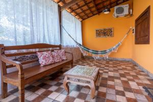 a living room with a hammock and a couch at Pousada Alta Vista - Inhotim in Brumadinho