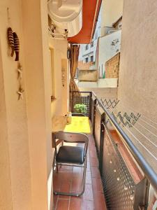 a balcony of a building with a table and a chair at Apartamento Sant Josep in Canet de Mar