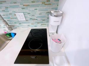 a bathroom with a sink and a trash can at Reel Paradise steps to bay beach fishing dock in Bradenton Beach
