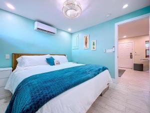 a bedroom with a large bed with a blue wall at Reel Paradise steps to bay beach fishing dock in Bradenton Beach