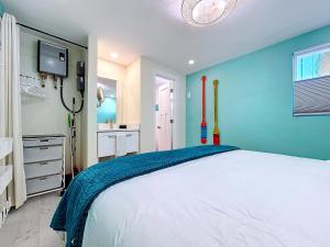 a bedroom with a large white bed and a tv at Reel Paradise steps to bay beach fishing dock in Bradenton Beach +16 photos