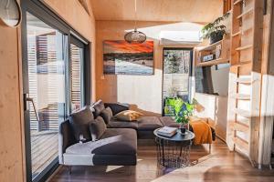a living room with a couch and a table at Unique Hideaway by Krøderen - Beach, Boat & Hiking in Ørgenvika