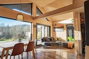 a kitchen and living room with a table and chairs at Unique Hideaway by Krøderen - Beach, Boat & Hiking in Ørgenvika