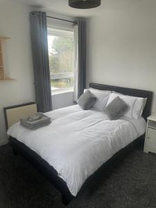 a bedroom with a white bed with a window at Bridgewater Court 2 in Southampton
